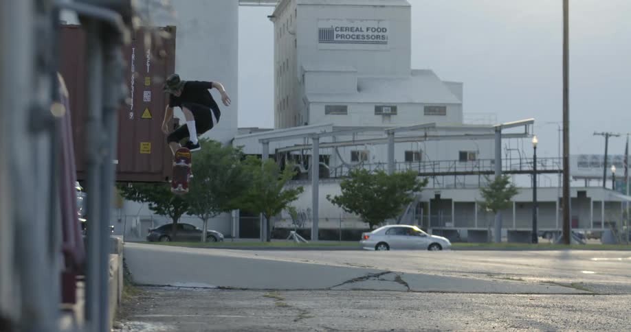 A skateboarder jumps over concrete