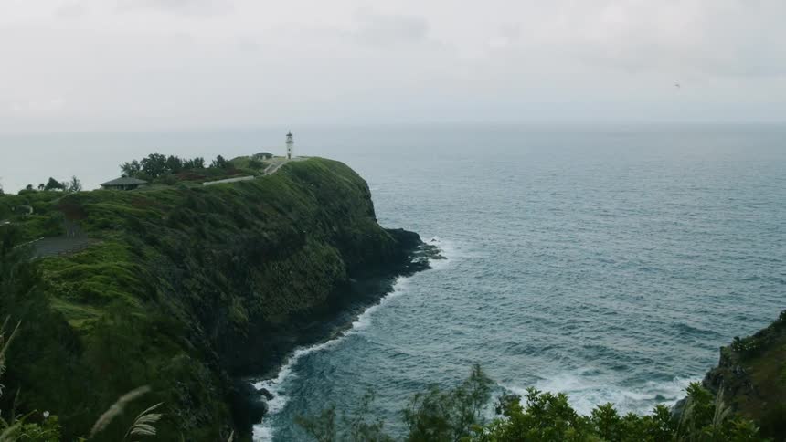 The tide flows towards the cliff on the shore