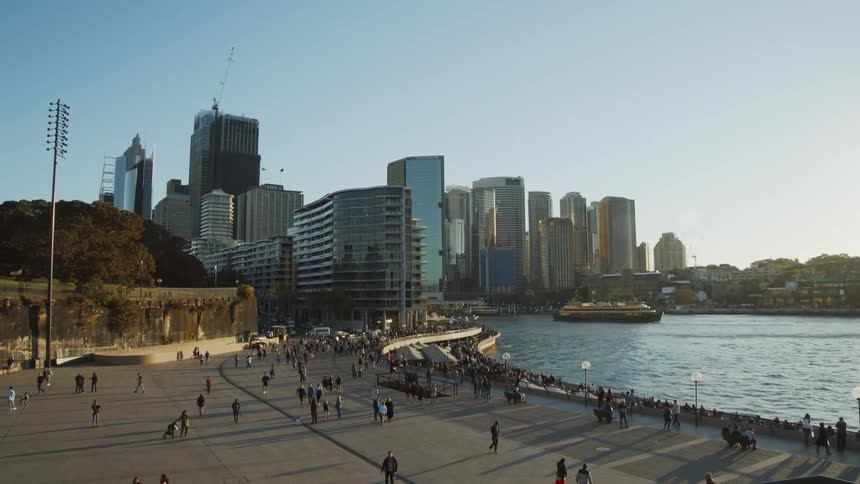 Pedestrians walk along the city pier