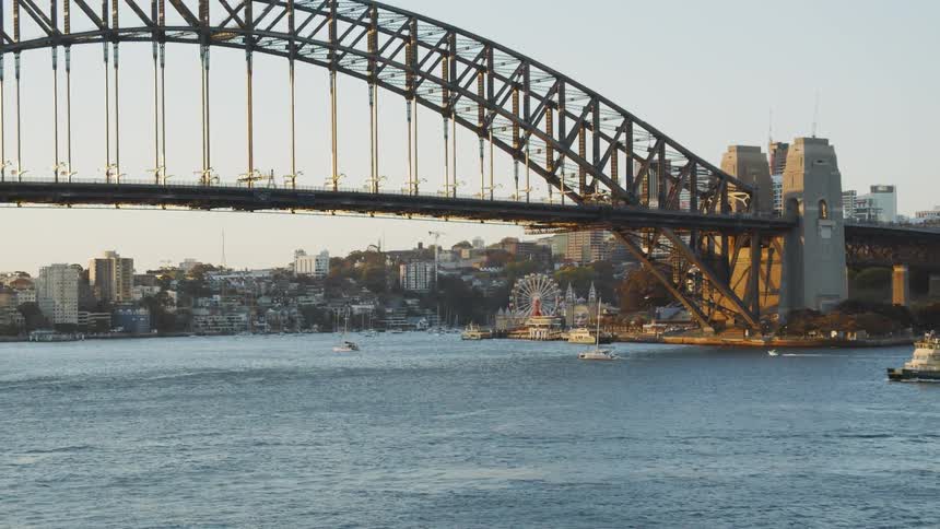 Boats travel under the city bridge