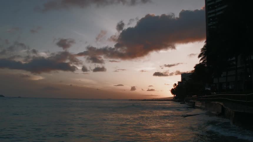 Water flowing up to the shore at sunset