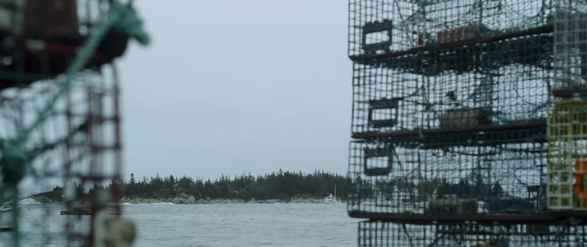 Fishing cages are stacked on the shore