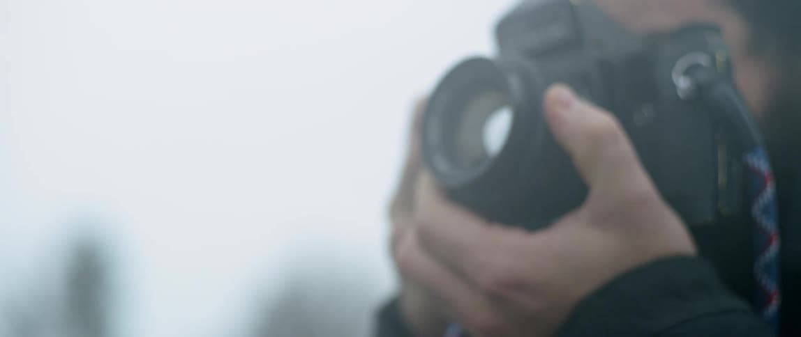 Man takes a picture outside with a camera