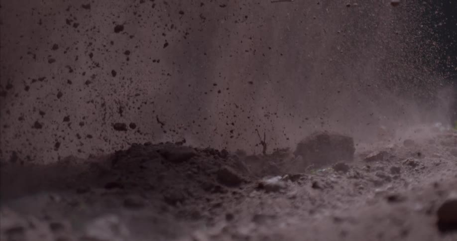 Dirt and rocks blowing up in the air and landing