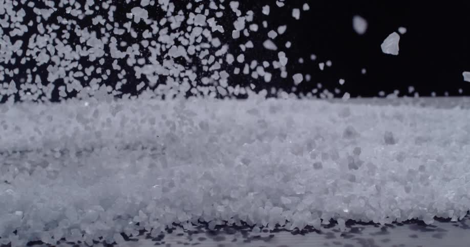 A bunch of white crystals toss in the air and fall down
