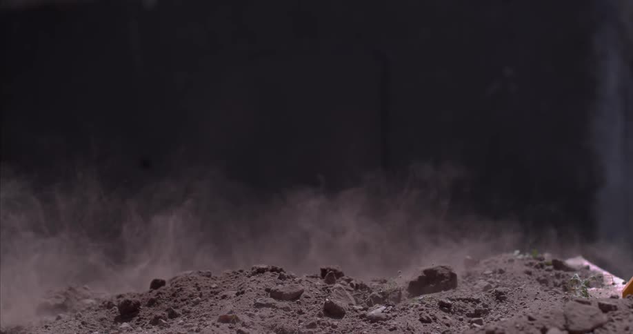 Dirt and rocks explode and then the dust settles
