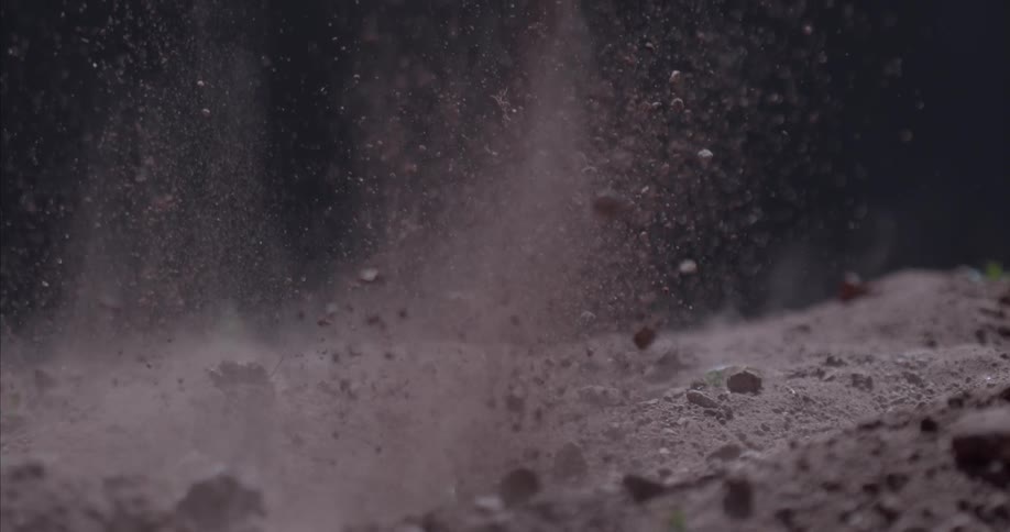 Dirt and rocks explode upwards and then settle