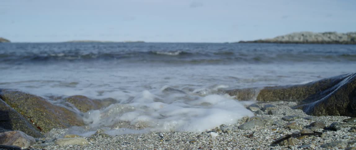 Ocean waves wash ashore on a clear day