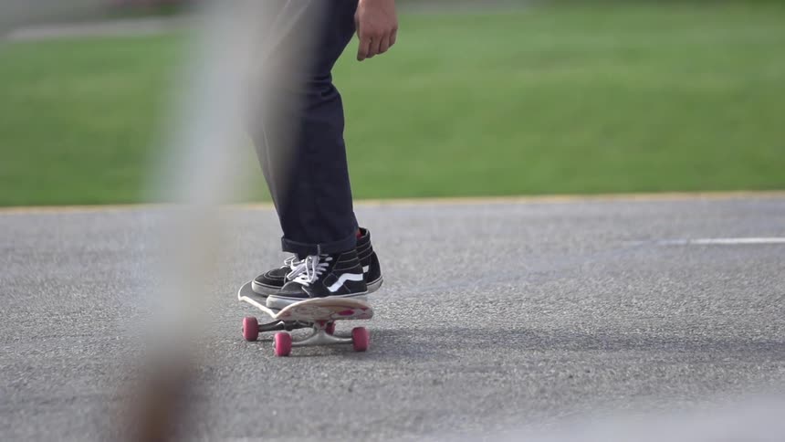 Man running forward in slow motion and getting on a skateboard
