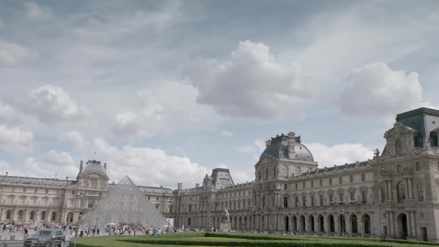 People walk outside at the louvre museum