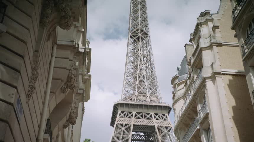The eiffel tower stands tall above the other city buildings