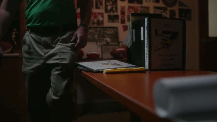 A man walks into a room with sports memorabilia