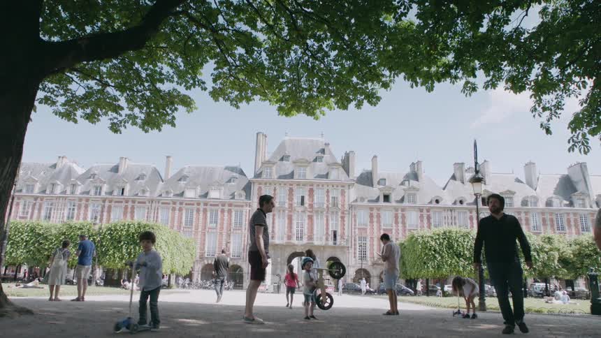 Children ride bikes and scooters in a city park