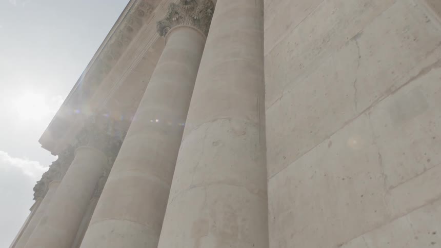 The columns of a building have ornate tops