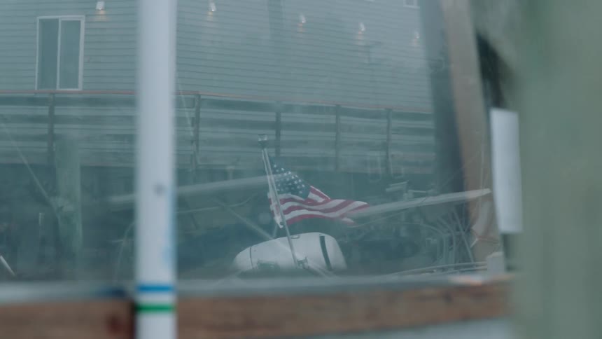 The wind is blowing the flag outside