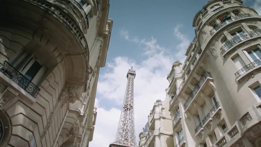 Several buildings near a large tower in a city