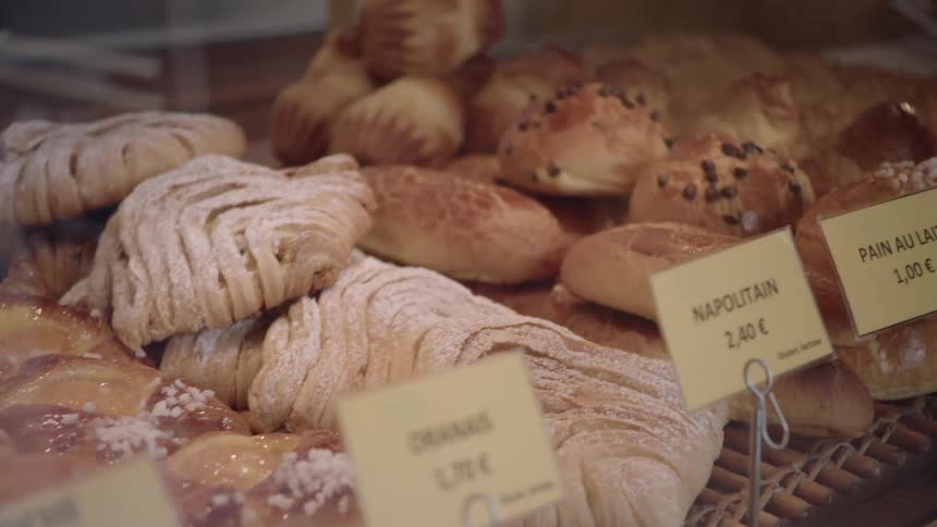 Pastries are displayed for sale in a case