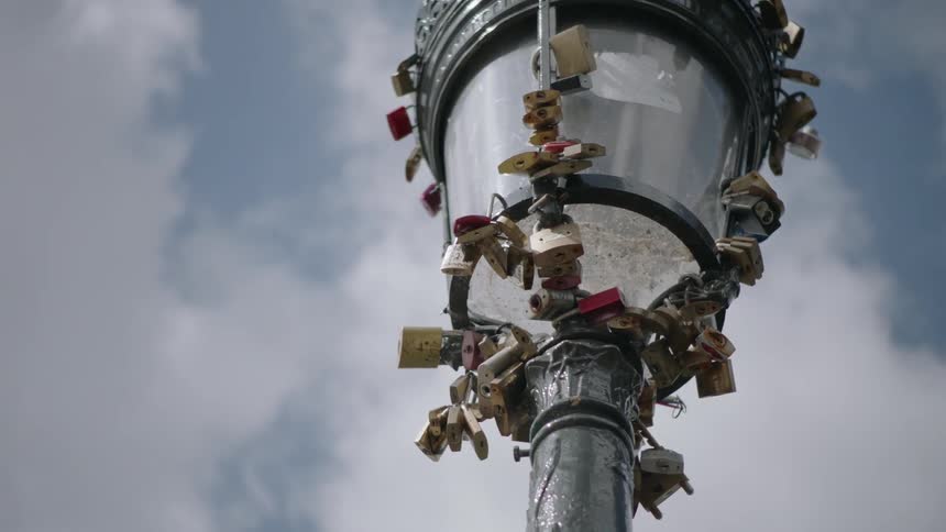 Locks are attached to a street lamp in paris france
