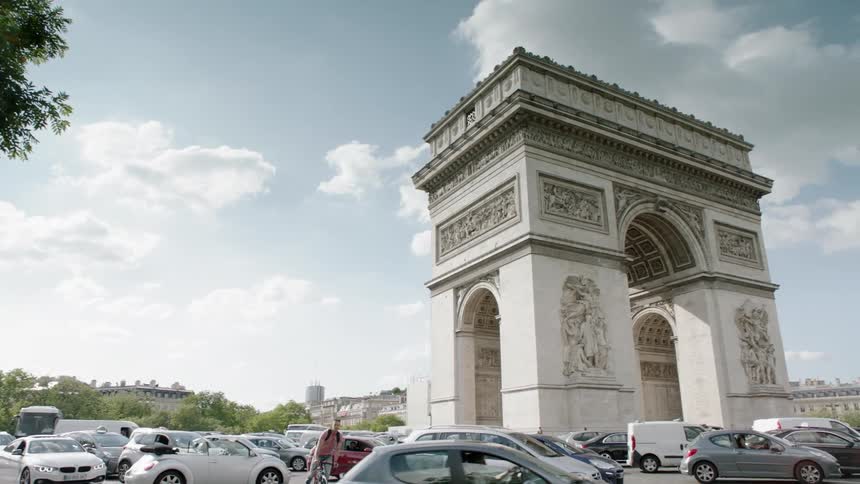 Cars drive on a city street