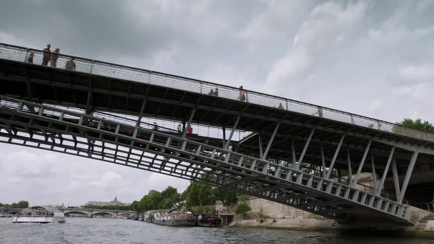 People walking on a bridge over a river