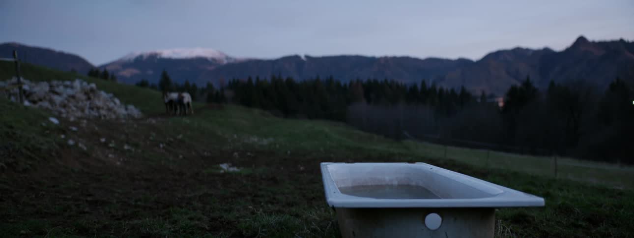 A tub sits on the hill on a cloudy day