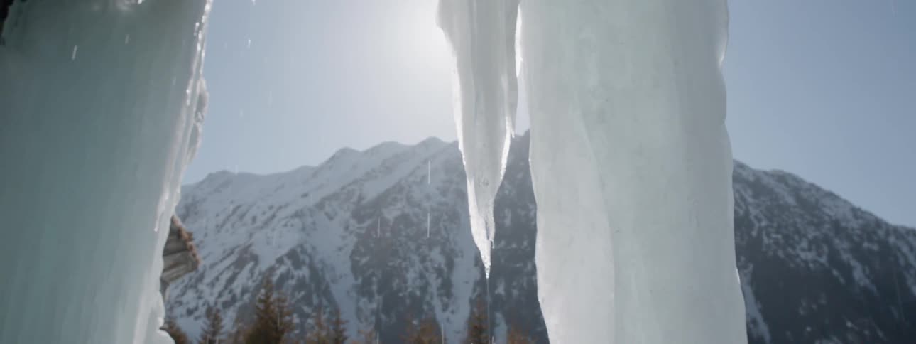 Sunlight shines on melting icicles in the mountains