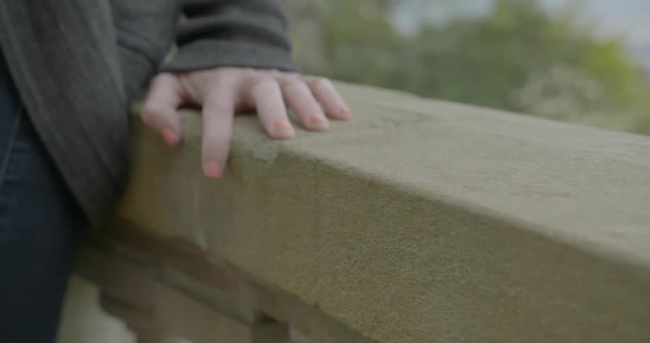 A person leaning on a railing