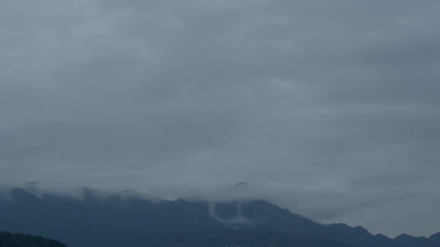 Clouds float over a mountain range
