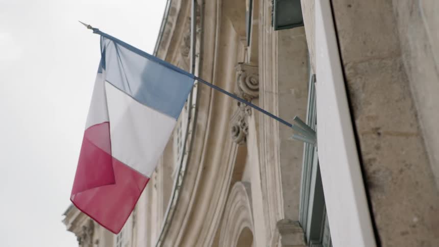 Flag on the outside of a building blows in the wind