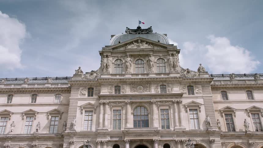 The french flag flies over the louvre