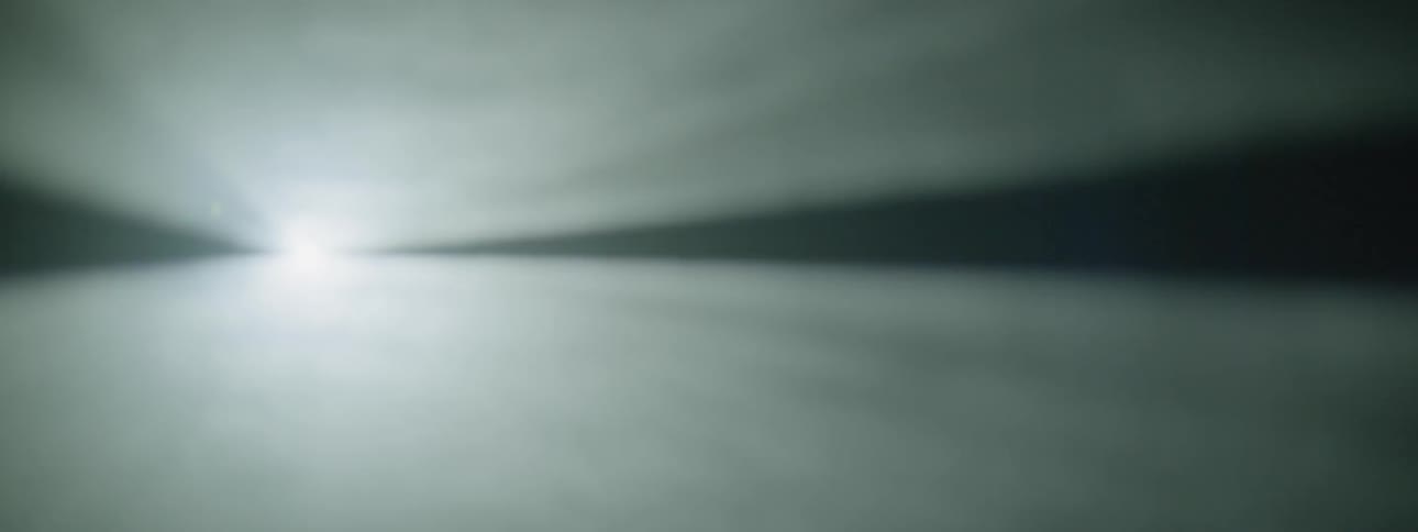 Smoke floats in front of a strobe light