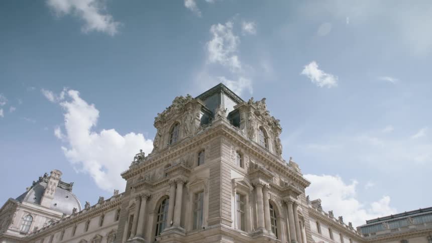 Clouds are hanging above an antique building during the day