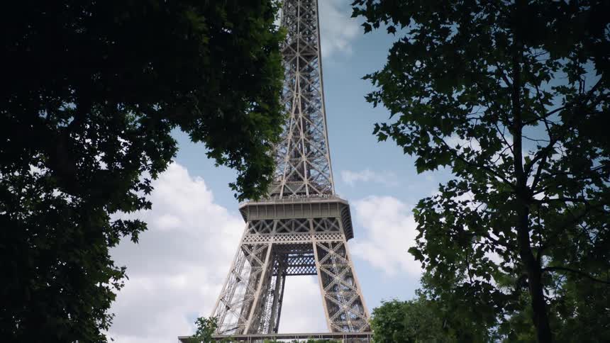 People stand beneath the eiffel tower
