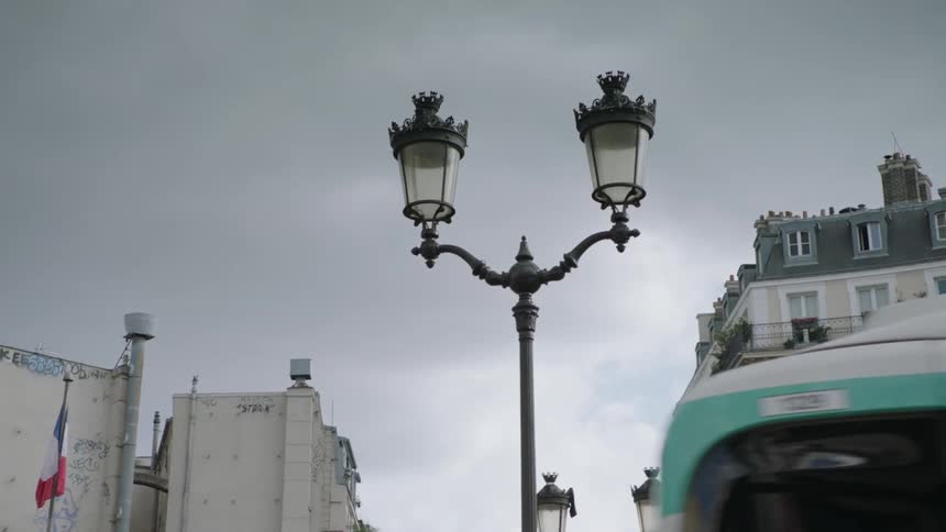 Bus goes down a street through the city on a cloudy day
