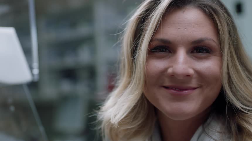 A woman turns her head and smiles