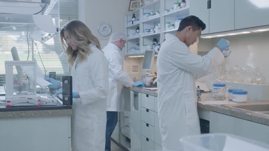 Men and women work in a lab