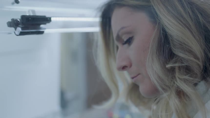 A blond woman works with pills