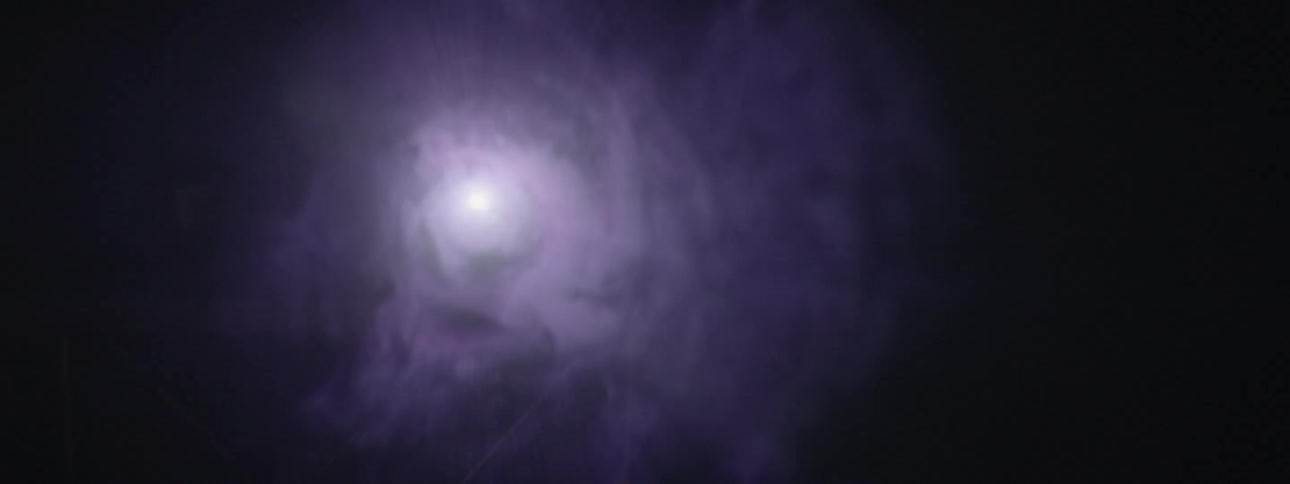 Smoke floats in front of a light