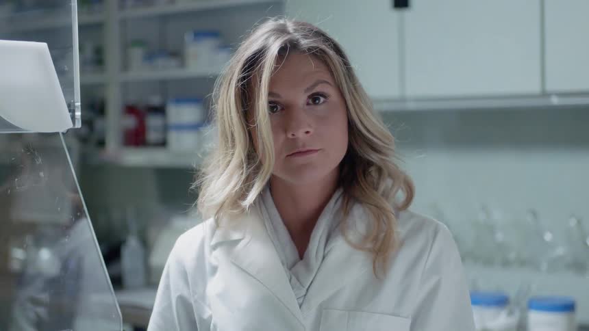 A scientist stands in a lab