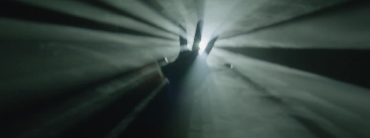A light shines onto an outstretched hand in a smoky area