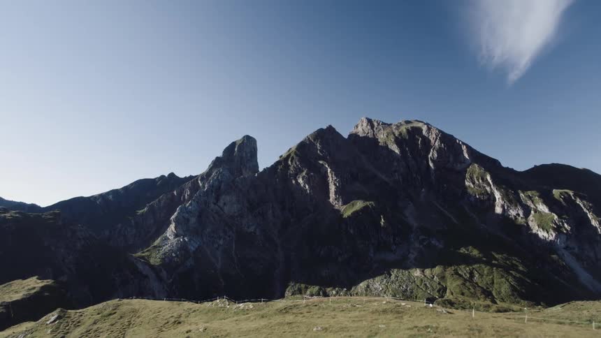 A rocky mountain ridge is shown on a clear day