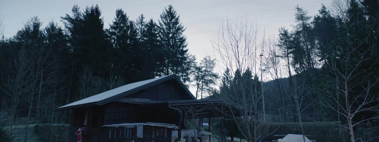 A truck drives past the snow covered home