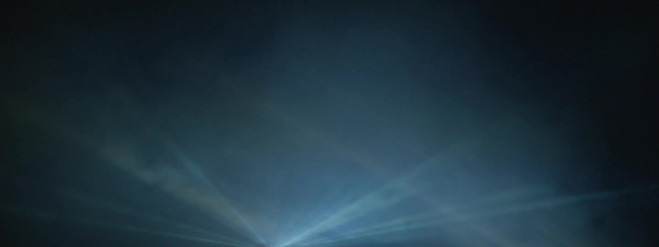 Smoke floats in front of strobe lights