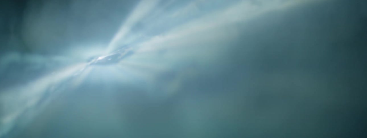 Smoke floats in front of a strobe light