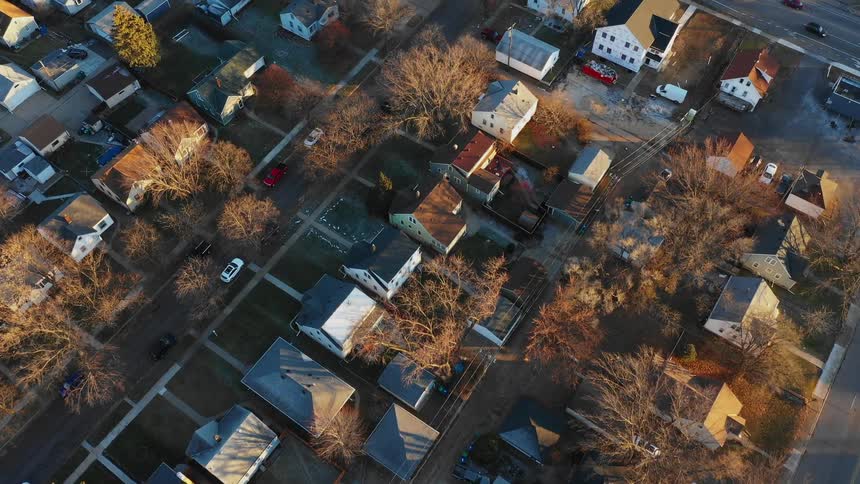 Cars drive in a neighborhood