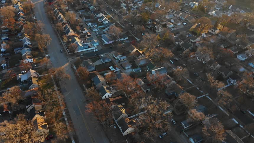 Vehicles drive down the quiet roads of the neighborhood