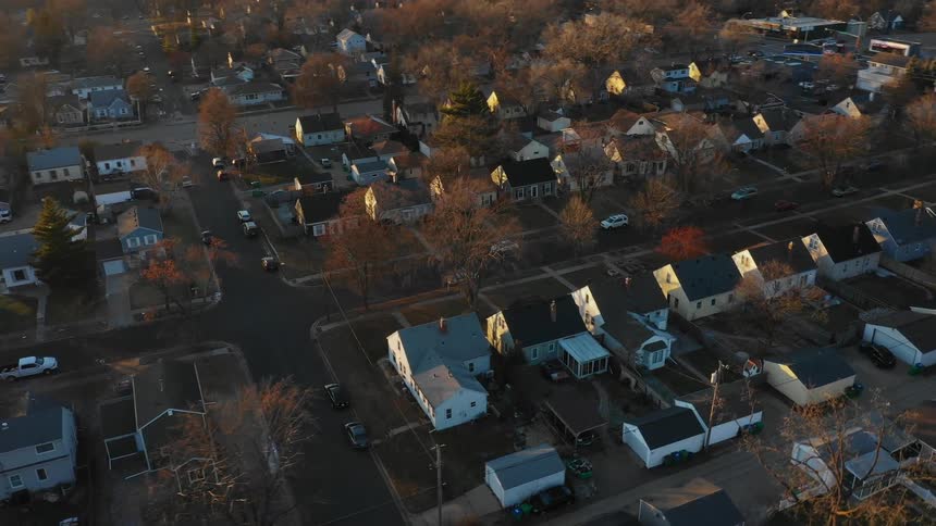 Houses sit quietly in a large town in the sunrise