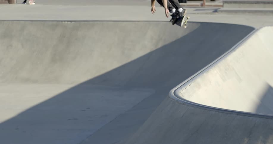 Man riding his skateboard in a park doing jumps