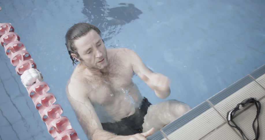 A man leans back in a swimming pool