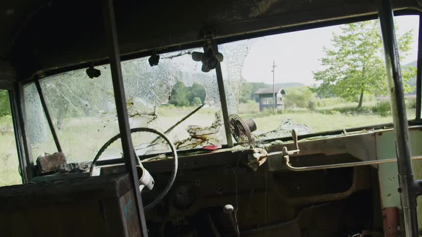 A bus is parked on a green field